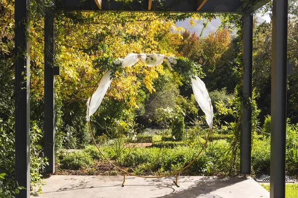 Wooden arbor and decorative wedding arch garden on sunny day, copy space. Nature, ceremony, wedding and celebration.