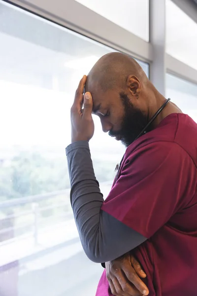 Sad African American Male Doctor Wearing Scrubs Looking Window Hospital — Stock Photo, Image