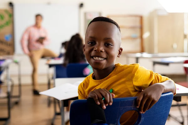 Portret Van Een Gelukkige Afro Amerikaanse Basisschooljongen Aan Een Bureau — Stockfoto