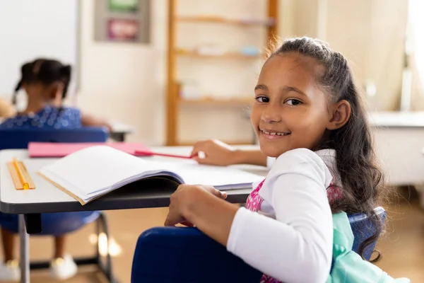 Portrait Happy Biracial Elementary Schoolgirl Sitting Desk Class Education Childhood — Stock Photo, Image