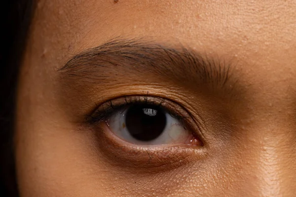 Close up of eye of asian woman with dark hair. Femininity, face, facial expressions, body, skin and beauty, unaltered.