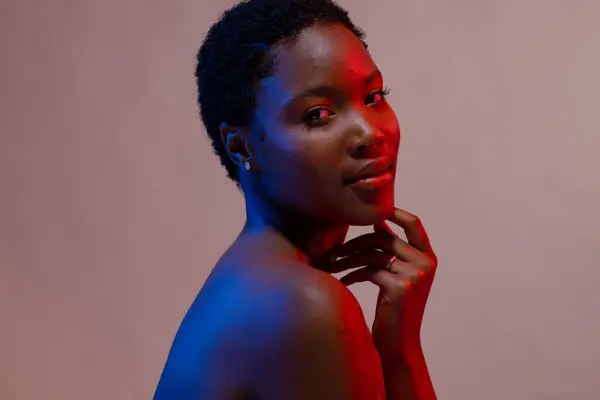 African American Woman Short Hair Touching Chin Blue Red Light — Stock Photo, Image