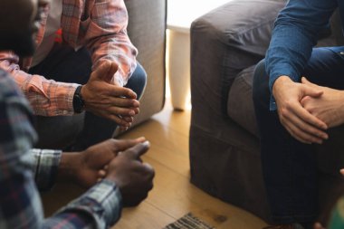 Hands of diverse group of friends talking and supporting each other on therapy session. Mental health, therapy, friendship and support, unaltered. clipart