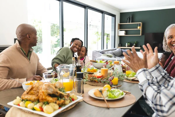 African american parents, children and grandparents celebrating at thanksgiving dinner