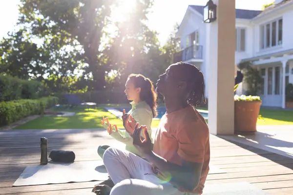 Happy Diverse Couple Practicing Yoga Meditation Sitting Deck Sunny Garden — Stock Photo, Image