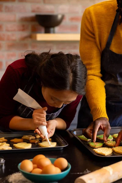 Focused Diverse Couple Aprons Decorating Christmas Cookies Kitchen Copy Space — Stock Photo, Image