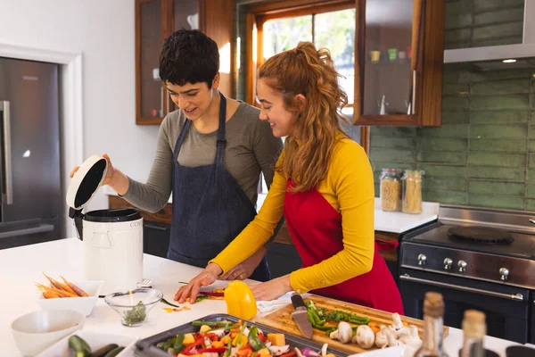 Happy Biracial Lesbian Couple Cooking Composting Vegetable Waste Kitchen Ecology — Stock Photo, Image