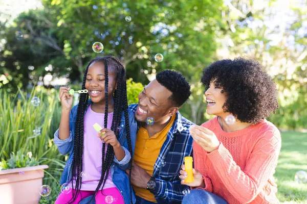 Happy African American Father Mother Daughter Blowing Bubbles Sunny Garden — Stock Photo, Image