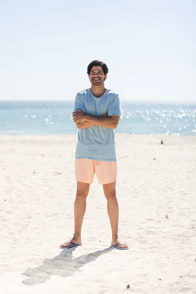 Young Biracial Man Stands Smiling Sunny Beach Casual Beachwear Suggests — Stock Photo, Image