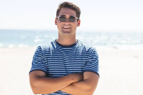Young Man Stands Confidently Sunny Beach Casual Beachwear Suggests Relaxed — Stock Photo, Image