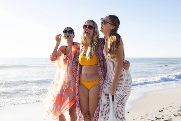 三位年轻女子享受一个阳光灿烂的海滩日 该小组由两名白人妇女和一名白人妇女组成 她们在户外度过了快乐的时光 — 图库照片