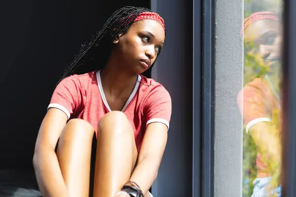Young African American Woman Gazes Out Window Deep Thought She — Stock Photo, Image