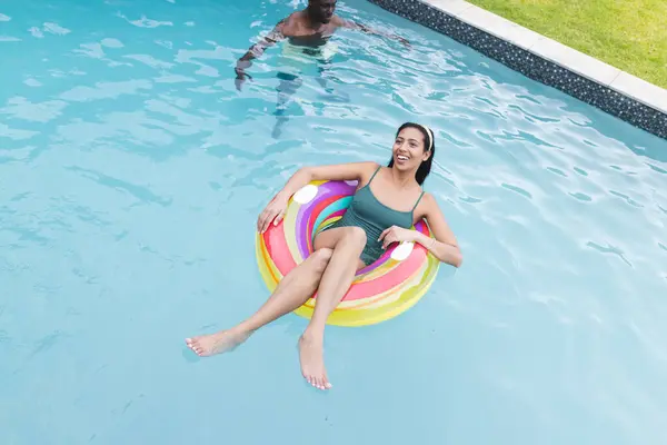 Young Biracial Woman Lounges Colorful Pool Float Smiling Background Young — Stock Photo, Image