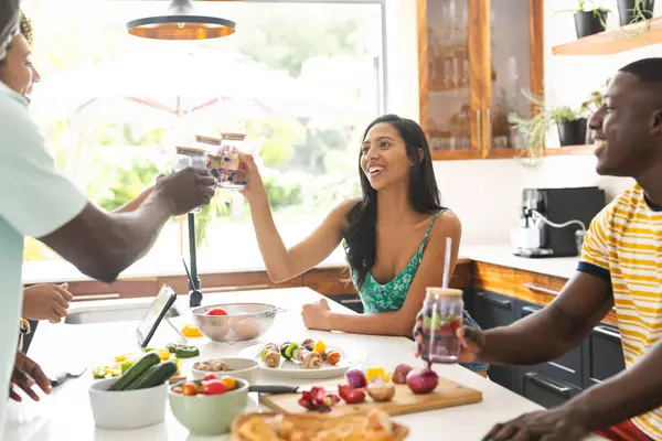 Diverse Group Enjoys Meal Sunny Kitchen Sharing Laughter Drinks Setting — Stock Photo, Image