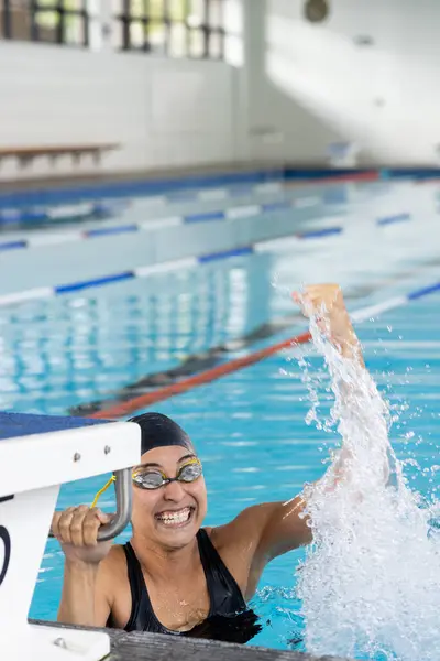 Biracial Young Female Swimmer Wearing Goggles Celebrating Indoors Pool Copy — Stock Photo, Image