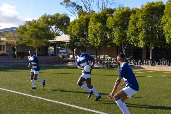 Three African American Young Male Athletes Wearing Sportswear Playing Rugby — Stock Photo, Image