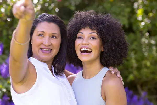 Mature Biracial Mother Points Young Daughter Smiles Her Garden Both Stock Picture