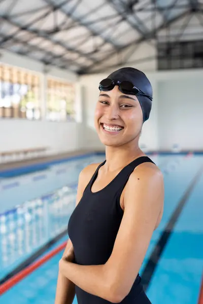 Biracial Young Female Swimmer Standing Pool Indoors Arms Crossed Smiling 스톡 이미지