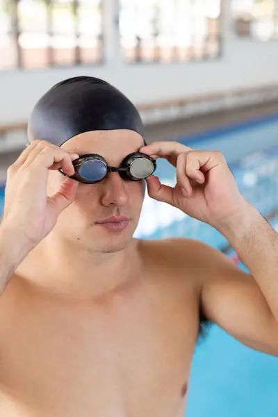 Caucasian Young Male Swimmer Adjusting Goggles Standing Pool Indoors Has 스톡 사진
