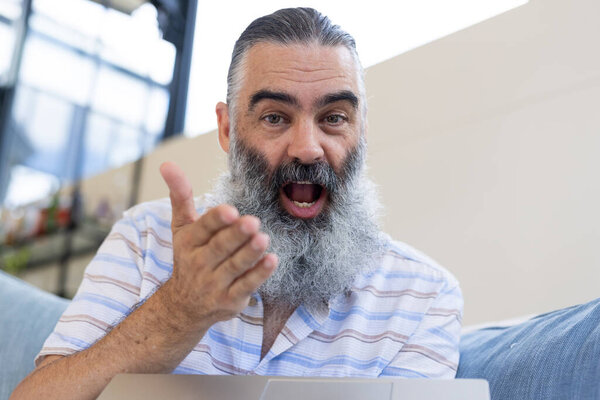 Smiling Senior Man Gesturing While Video Chatting Laptop Home Technology Royalty Free Stock Photos
