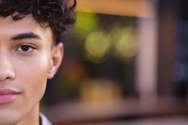 stock image Close-up of teenage boy with curly hair, half face visible, looking confident, copy space. Confidence, portrait, determination, expressive, motivation, self-assured