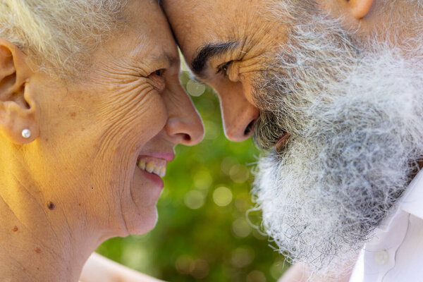 Senior bride and groom smiling and touching foreheads, at outdoor wedding. Friendship, happiness, togetherness, bonding, elderly, companionship — Stock Image Senior Bride Groom Smiling Touching Foreheads Outdoor Wedding Friendship Happiness Royalty Free Stock Images