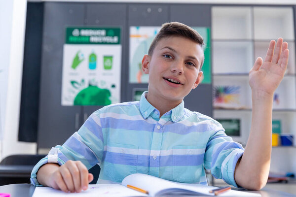 Happy Caucasian Schoolboy Sitting Desk Raising Hand Talking Class Copy Royalty Free Stock Images