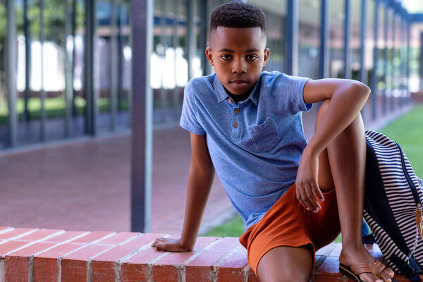 Portrait Serious African American Schoolboy Sitting Wall School Copy Space Stock Picture