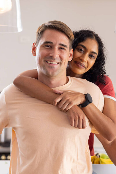 Embracing, smiling young couple enjoying time together at home. Love, relationship, happiness, bonding, togetherness, intimacy — Stock Image Embracing Smiling Young Couple Enjoying Time Together Home Love Relationship Stock Photo