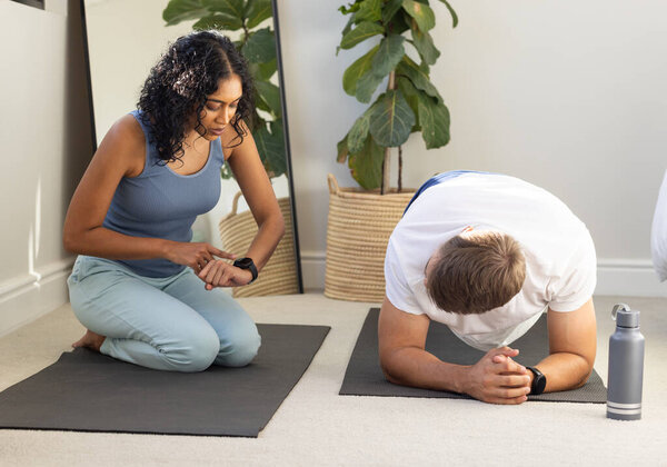 Woman timing man planking on yoga mat during home workout session. Fitness, exercise, home gym, training, healthy lifestyle, personal trainer — Stock Image Woman Timing Man Planking Yoga Mat Home Workout Session Fitness Royalty Free Stock Images