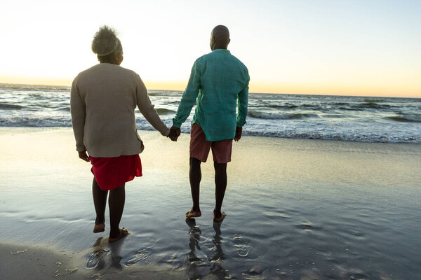 Senior African American Couple Enjoys Serene Beach Sunset Copy Space Stock Image