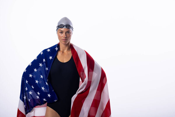 Female swimmer wrapped in the American flag, with copy space on white background. The young Caucasian woman exudes confidence and national pride. — Stock Image Female Swimmer Wrapped American Flag Copy Space White Background Young Stock Image