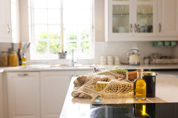 Close up of shopping bag with food lying on table in kitchen at home. Food, shopping and domestic life. — Stock Image Close Shopping Bag Food Lying Table Kitchen Home Food Shopping Stock Photo
