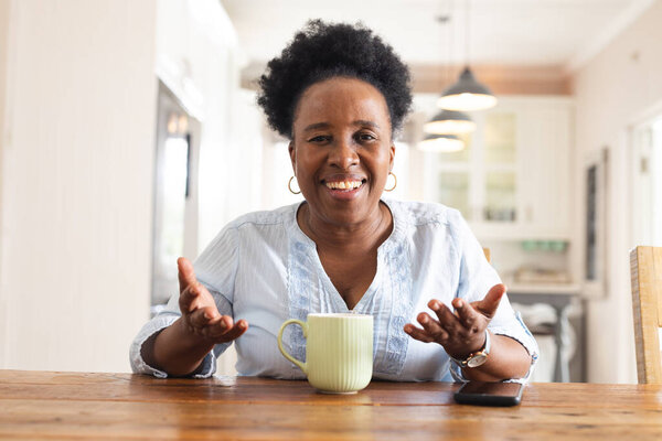 Portrait of happy senior african american woman having video call at home. Domestic life, retirement, technology and lifestyle, unaltered. — Stock Image Portrait Happy Senior African American Woman Having Video Call Home Royalty Free Stock Photos