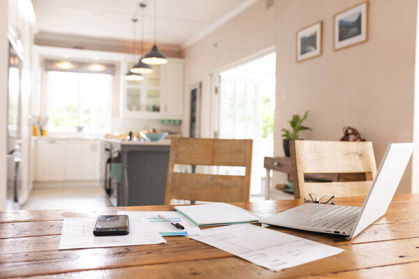 Close up of documents, smartphone and laptop lying on table over kitchen at home. Technology and domestic life. — Stock Image Close Documents Smartphone Laptop Lying Table Kitchen Home Technology Domestic Stock Picture