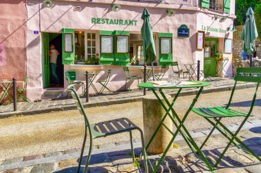 Parisian cafe with tables is on the street in district Montmartre, Paris, France