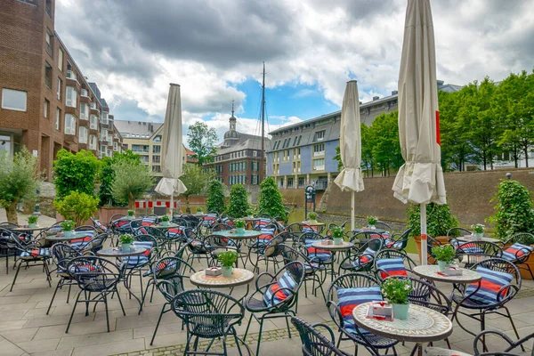 The street cafe with elegant tables awaits guests, Dusseldorf, Germany