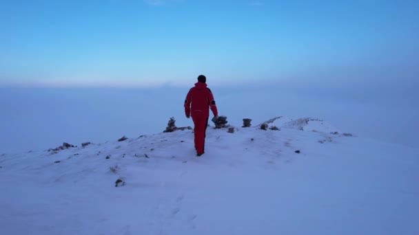 Ένας Ορειβάτης Κόκκινη Στολή Στέκεται Στην Κορυφή Του Βουνού Κοιτάζει — Αρχείο Βίντεο