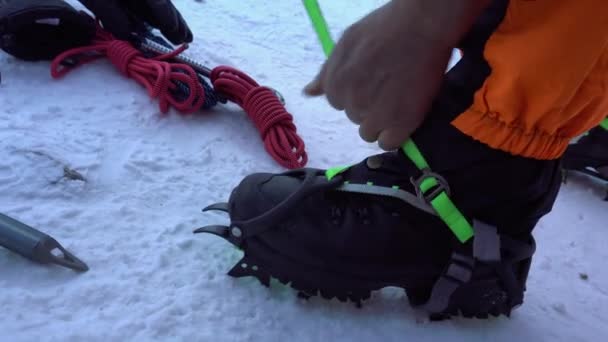 Guy Puts Mountain Cats Spikes His Shoes Metal Spikes Chains — Stockvideo