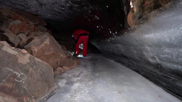 Guy Backpack Moves Ice Cave Beautiful Ice Walls Shimmer Dark — 图库视频影像