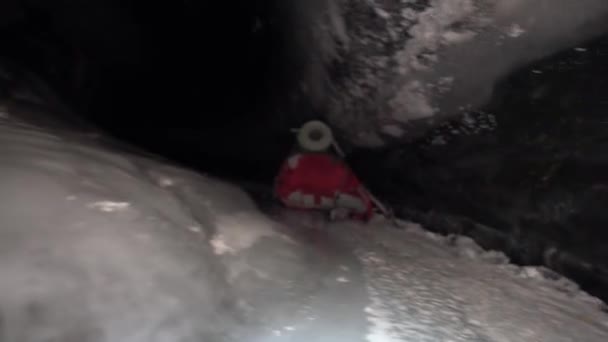 Guy Backpack Moves Ice Cave Beautiful Ice Walls Shimmer Dark — Stock video