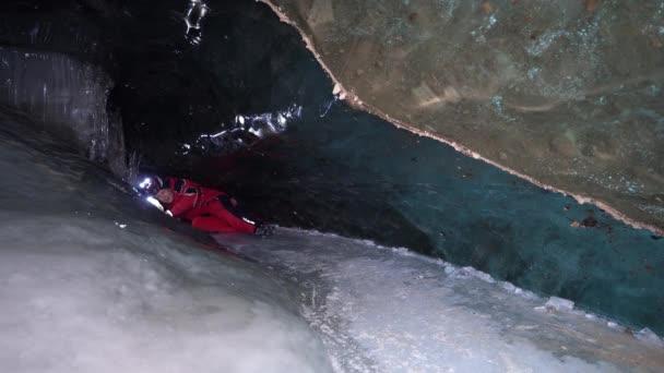 Guy Backpack Moves Ice Cave Beautiful Ice Walls Shimmer Dark — Wideo stockowe