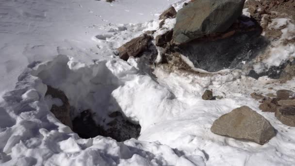 Mountaineer Backpack Descends Ice Cave Big Rocks Hole White Snow — Stock video