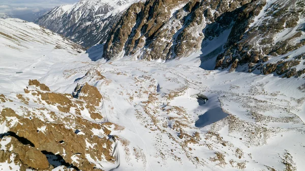 山上有一个巨大的冰冻冰川 还有很多游客 在雪地里散步 用冰块拍照 从无人机上俯瞰 冰就像大理石深浅灰色调 阿拉木图 — 图库照片