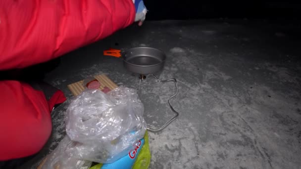 Guy Cooks Food Gas Ice Cave Climber Lights Burner Cuts — Video