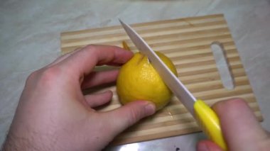 Çürümüş bir limonla taze bir limon kestim. Ortası siyah şeritli sarı sulu limon. Deneyden sonra her şey içten yanar. Bir bıçak ve tahta bir tahta..