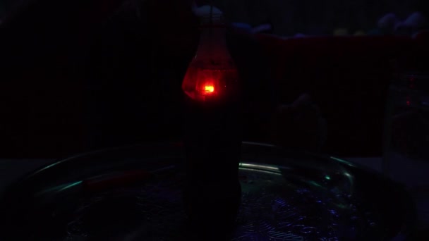 一个火焰喷射器在一瓶可口可乐液体中燃烧着 在透明瓶子中的水下燃烧火花的经验 在水里生火瓶子里冒出大量的烟 — 图库视频影像