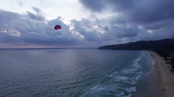 일몰에 보트에 연결된 낙하산으로 파란색 보라색 거대한 구름과 어두운 구름의 — 비디오