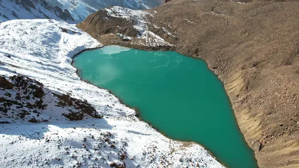 有翡翠水的高山湖像一面镜子 从无人机上俯瞰 莫朗湖被部分冻结了 有些地方有大石头和大雪 是一座冰川 管道和房屋清晰可见 — 图库照片
