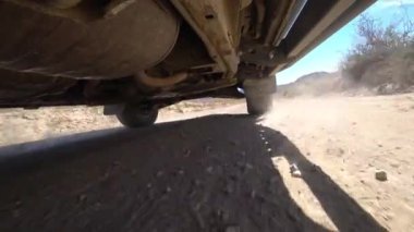 Kamera arabanın altına sabitlenmiş, direksiyon ve süspansiyon manzarası. Off-road, kayalar ve toz. Süspansiyon off-road ve tümsekler iyi çalışıyor. Terk edilmiş bölge. Lastik deformasyonu